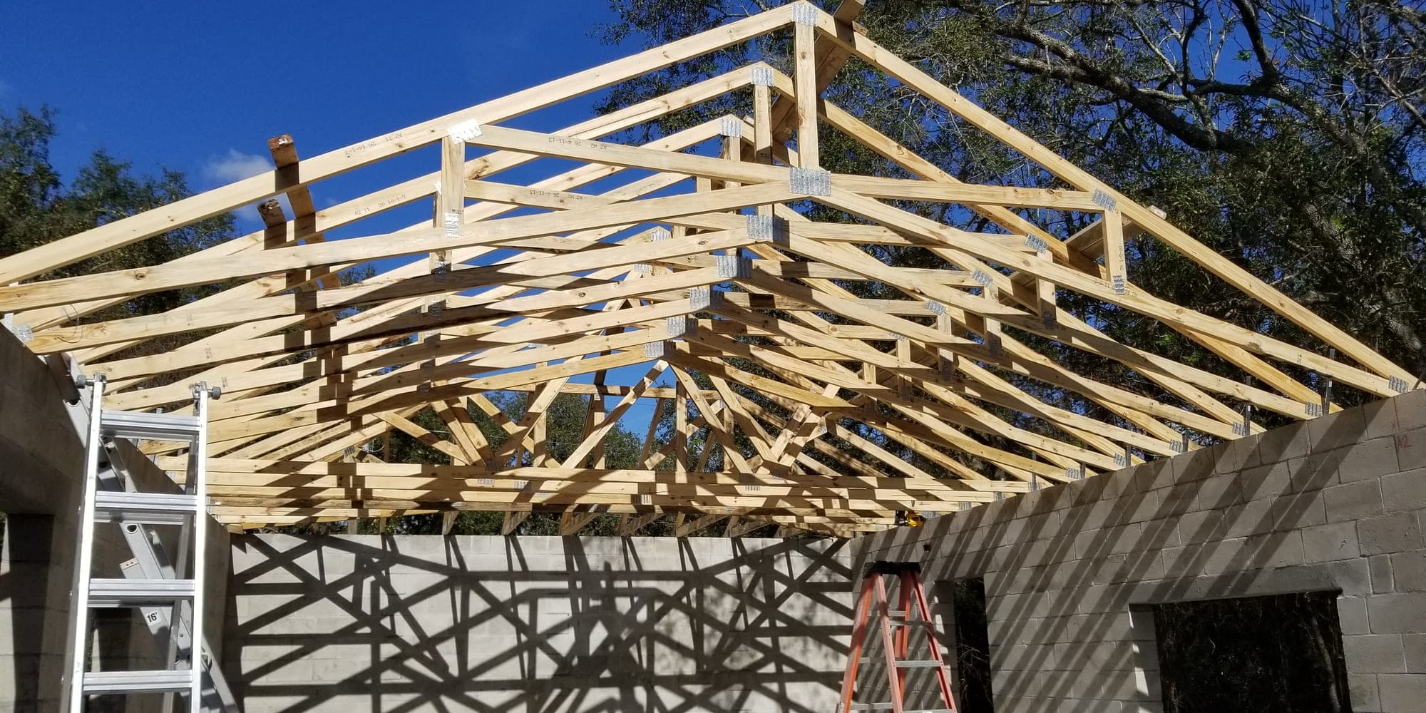 Roof trusses set and braced on block walls of a new construction build