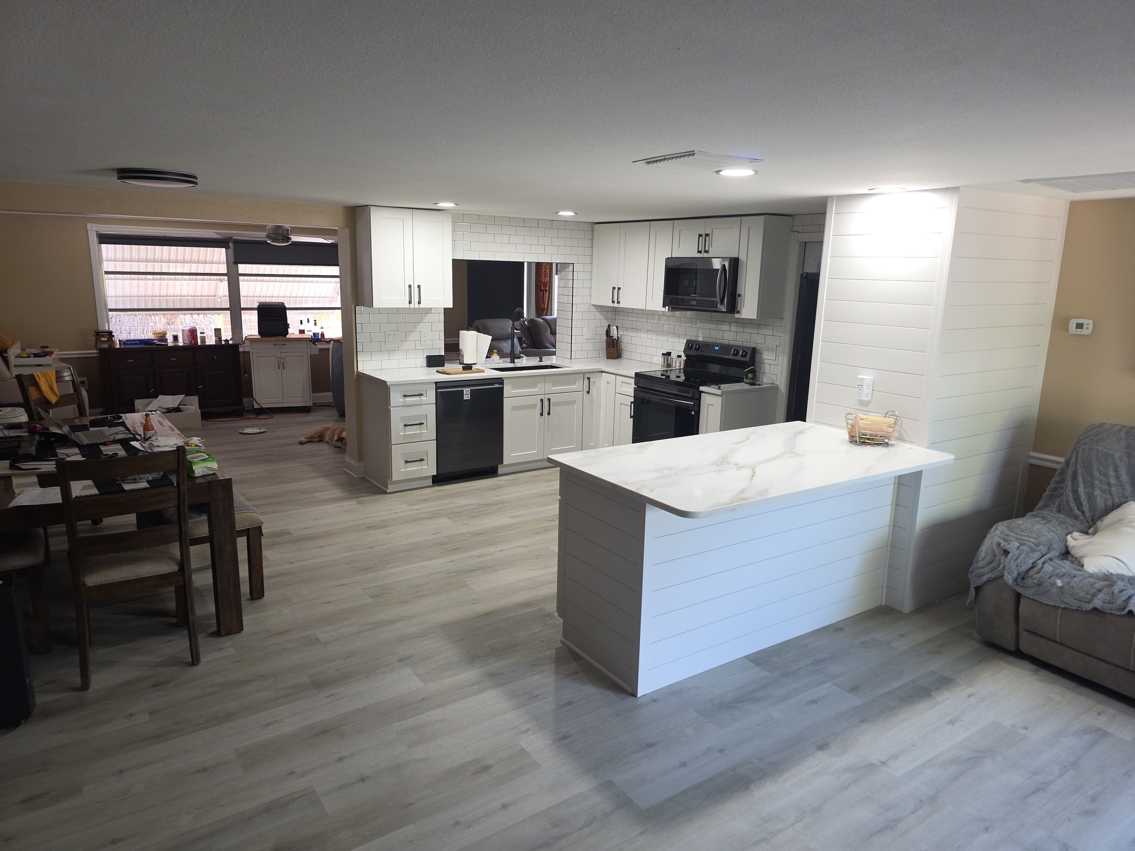White shaker kitchen with shiplap peninsula and quartz countertop, renovated by Jason Sutliff Renovations